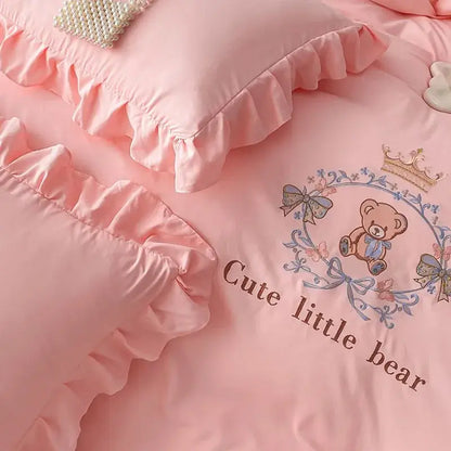 Pink embroidered bear cotton bed skirt set with satin fabric, ruffled edges, and crown-accented bear design