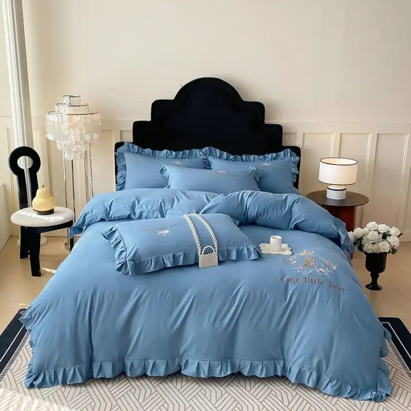 Light blue ruffled cotton bed skirt set with delicate floral embroidery and cute little bear design for bedroom use