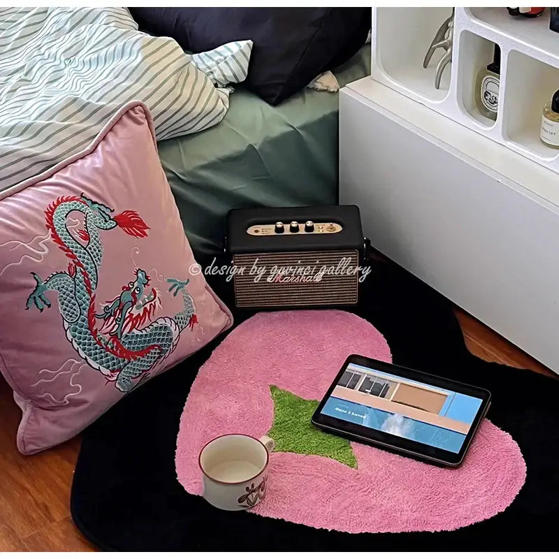 Pink embroidered dragon velvet pillow cover with pink strawberry-shaped rug and green leaf detail for living room decor