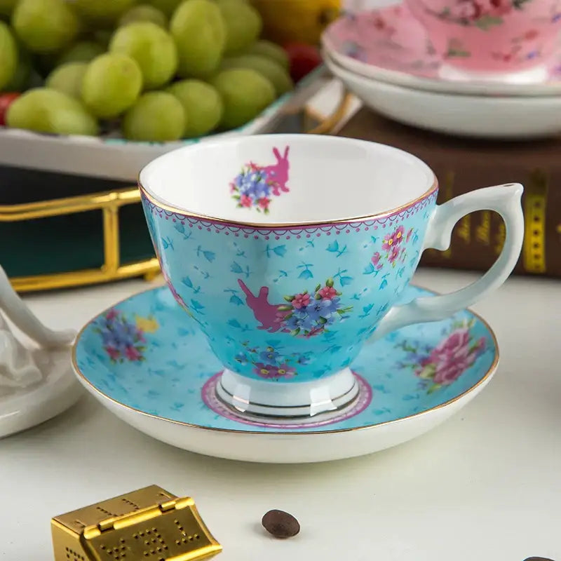 A delicate turquoise bone china flower tea cup set with pink floral and bunny motifs and gold trim for Phnom Penh afternoon