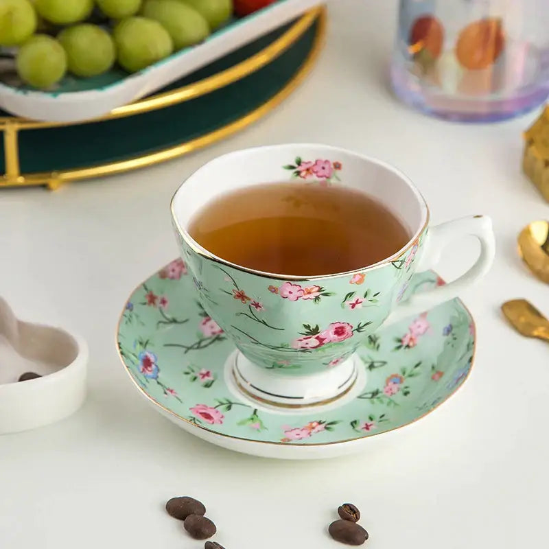 A delicate mint green bone china flower tea cup set with pink floral pattern and gold trim for phnom penh afternoon