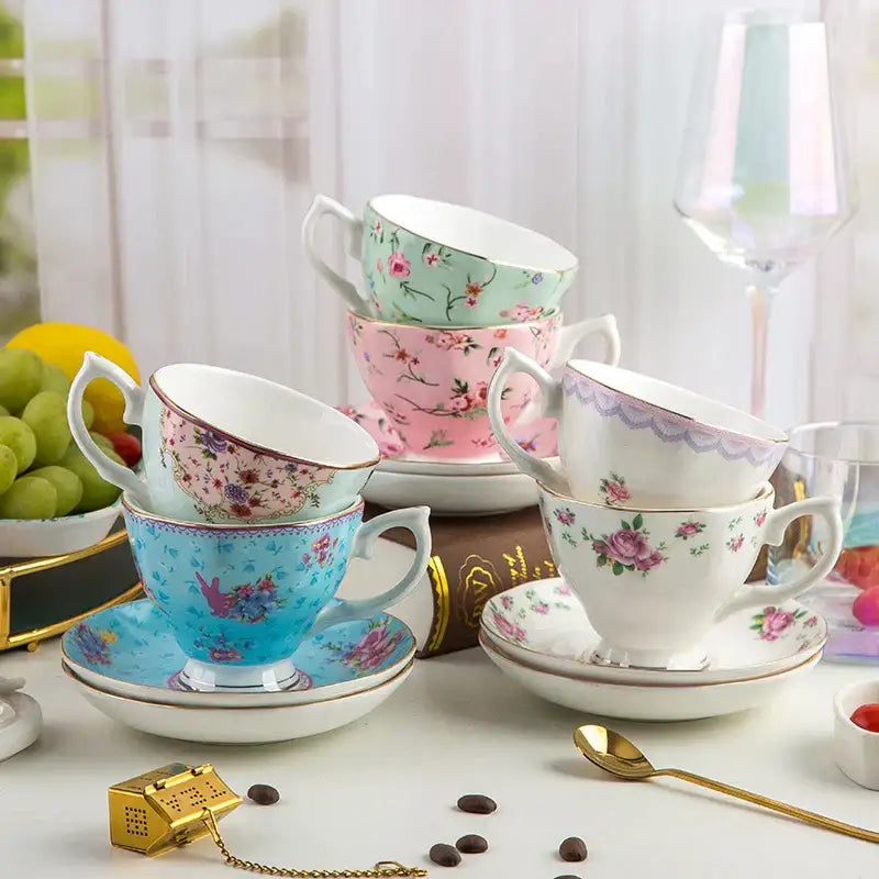 Pastel pink floral bone china flower tea cup set with gold trim stacked on matching saucers for phnom penh afternoon