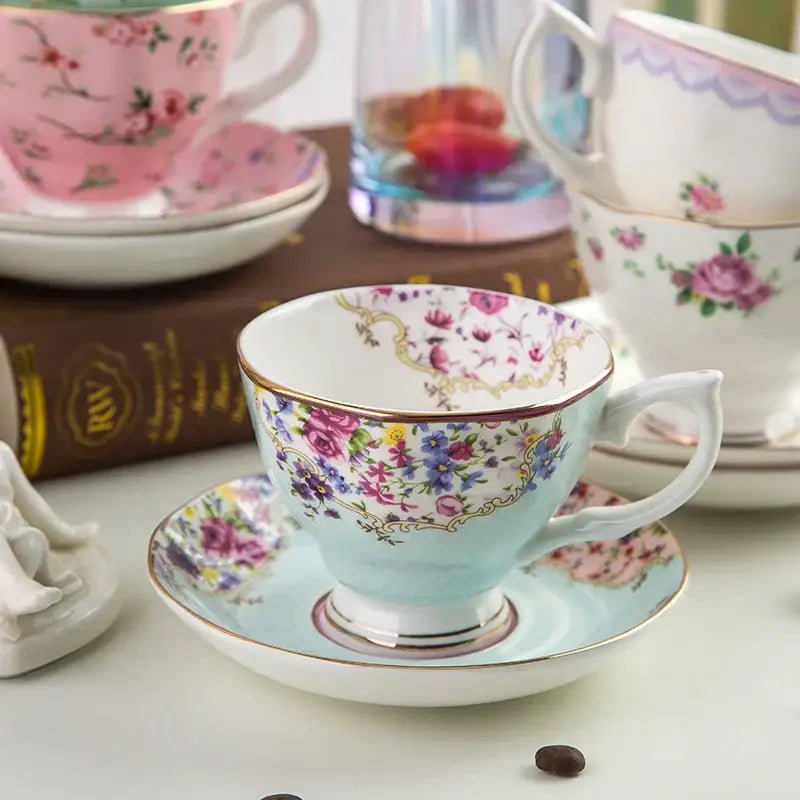 A delicate light blue porcelain flower tea cup with pink floral patterns and gold accents in a phnom penh tea cup set