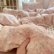 Pink floral double layer yarn bedspread set with delicate rose and green leaf patterns on soft textured fabric