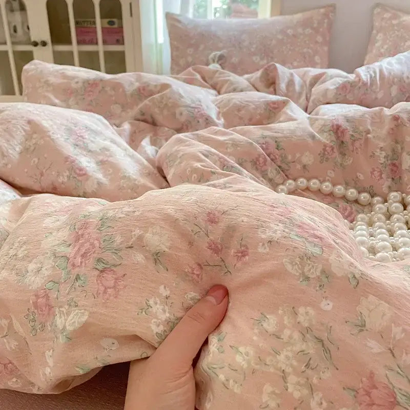 Pink floral double layer yarn bedspread set with delicate rose and green leaf patterns on soft textured fabric