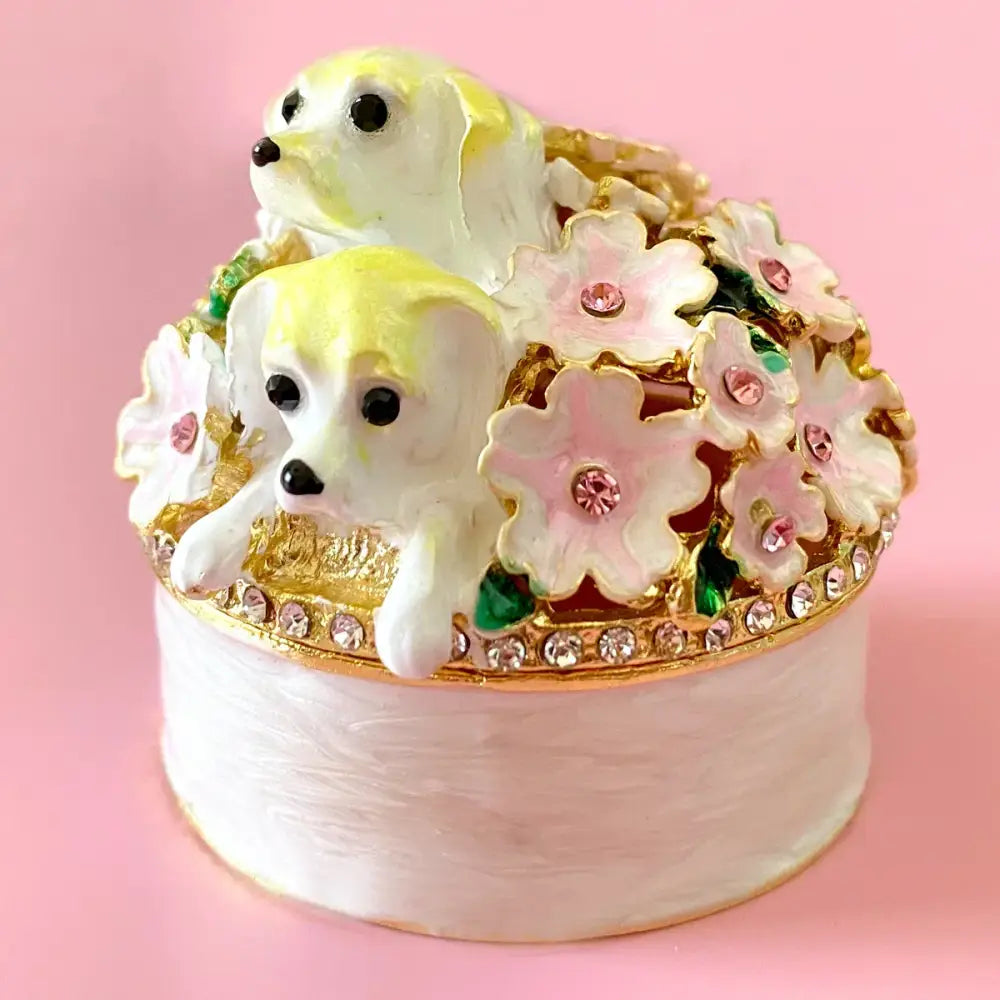 Delicate white and gold enamel jewelry trinket box with yellow puppy figurines and pink floral accents for storage case