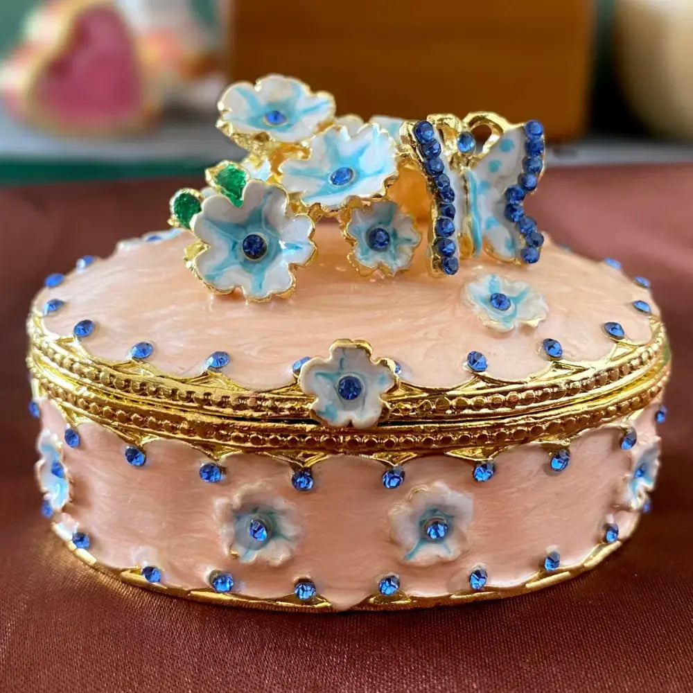 Pink floral heart jewelry trinket box with delicate enamel, gold trim, blue rhinestones, and turquoise accented flowers storage case
