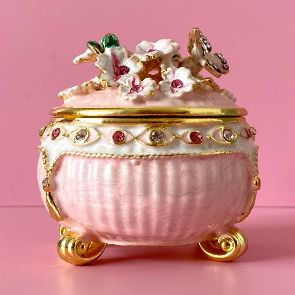 Pink porcelain jewelry trinket box with gold accents floral butterfly embellishments and gemstones storage case