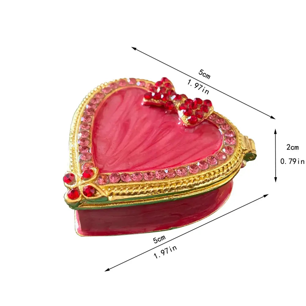 Pink floral heart jewelry trinket box with vibrant pink enamel, gold-toned rhinestone border, and red jeweled bow storage case