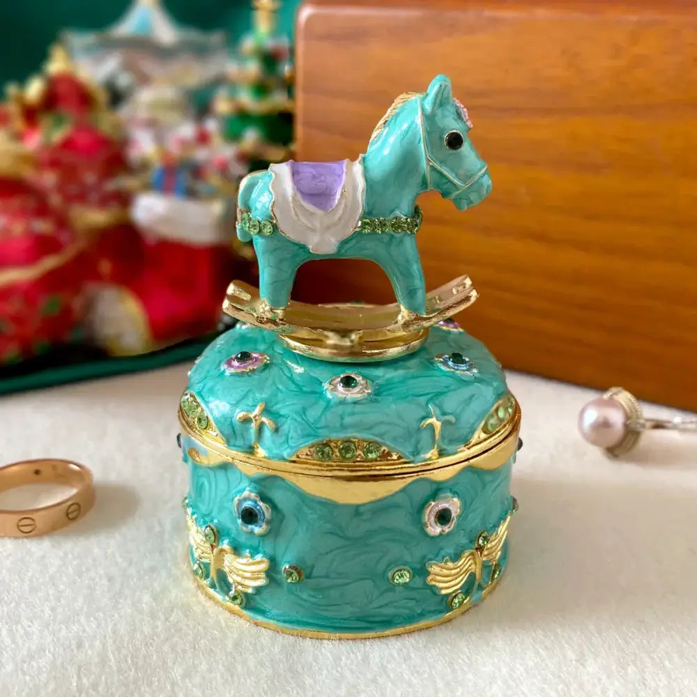 Turquoise enamel jewelry trinket box with rocking horse lid gold trim and green gemstones storage case