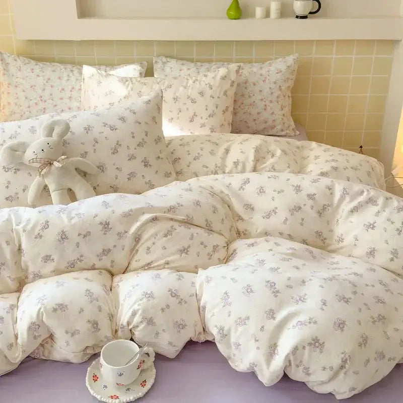 Cream-colored floral fitted sheet set with soft plush texture and delicate pastel blossoms in pink jacquard yarn