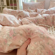 Soft pink floral jacquard fitted sheet set with delicate pastel blossoms and textured yarn for bedroom use