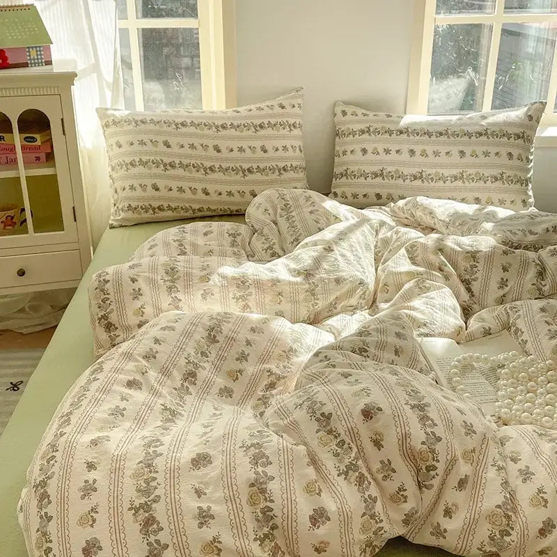 Cream-colored floral fitted sheet set with delicate green and beige stripes in soft textured yarn for bedroom use