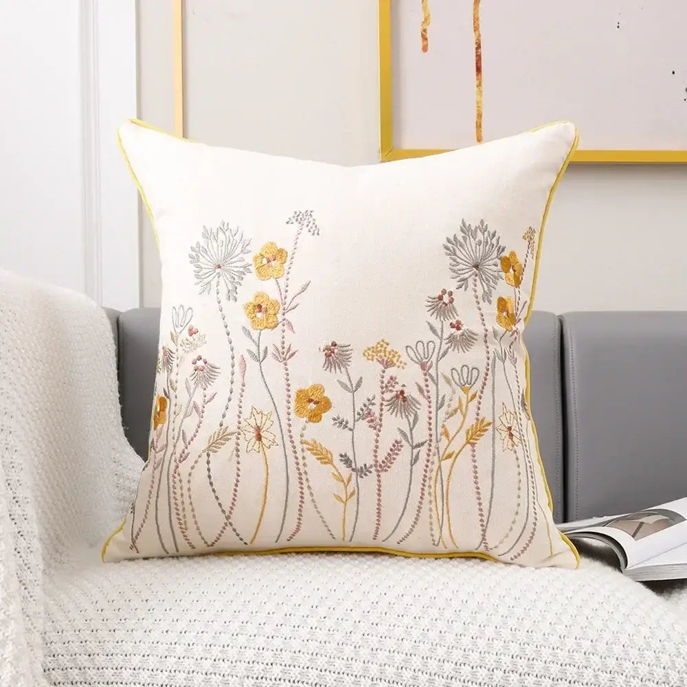 Cream-colored cushion cover with intricate pink flower farmhouse embroidery and yellow piping for living room decorbites 3d pink decor