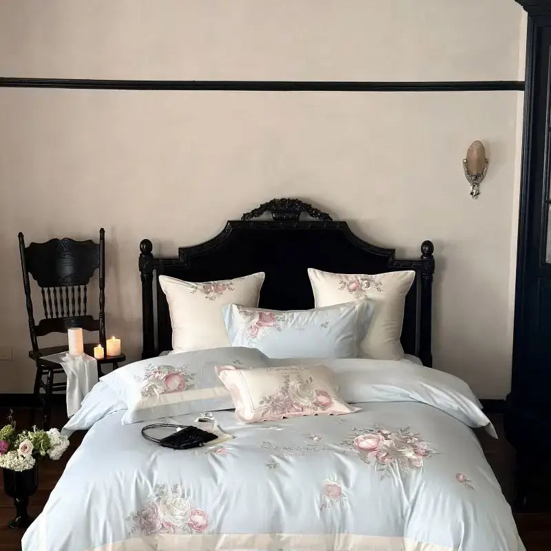 Light blue satin bedding set with delicate pink flowers embroidery and matching pillows for elegant bedroom decor