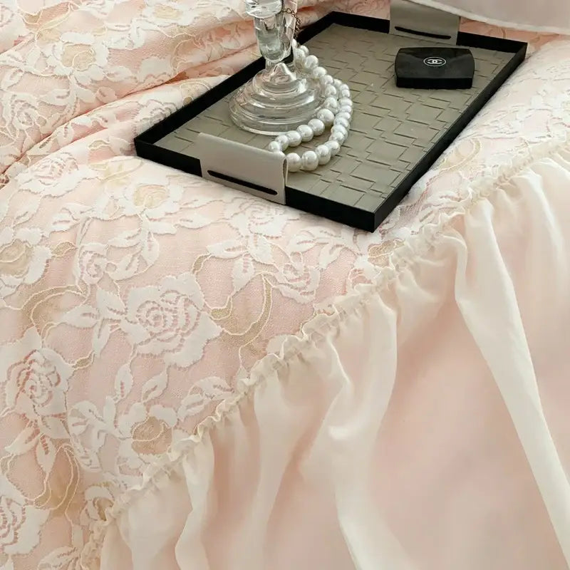 A delicate pink french princess bedding set featuring lace floral patterns and a soft ruffled hem for bedroom decor