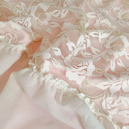 Delicate white floral lace overlay with soft pink satin lining and ruffled hem on pink french princess bedding set