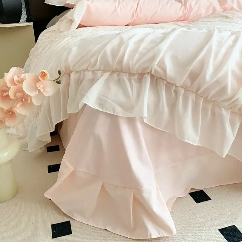 A soft pink satin bedding set with layered ruffles and matching pillowcase in pink french princess style