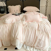 Soft blush pink french princess bedding set with lace detailing and ruffled layered fabric for elegant bedroom decor