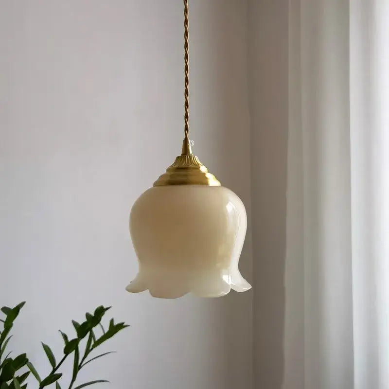Cream-colored glass pendant light with gold-toned metal fixture and twisted cord for kitchen glass copper led pendant lighting