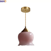 Pink glass copper led pendant light with gold-toned fixture and twisted cord for kitchen decor or lighting