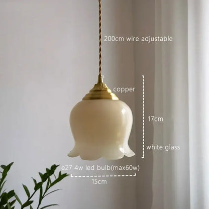 A delicate white glass copper led pendant light with copper finish and twisted wire suspension for kitchen decor