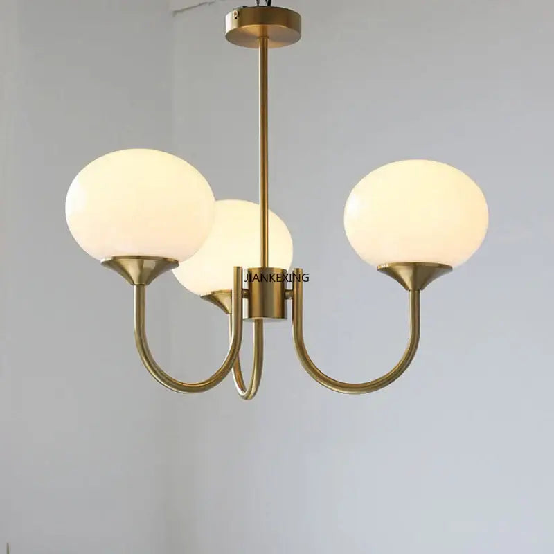 Brass-finished pendant lights with three frosted glass globes from decorbites designer loft pendant collection for bedroom decor
