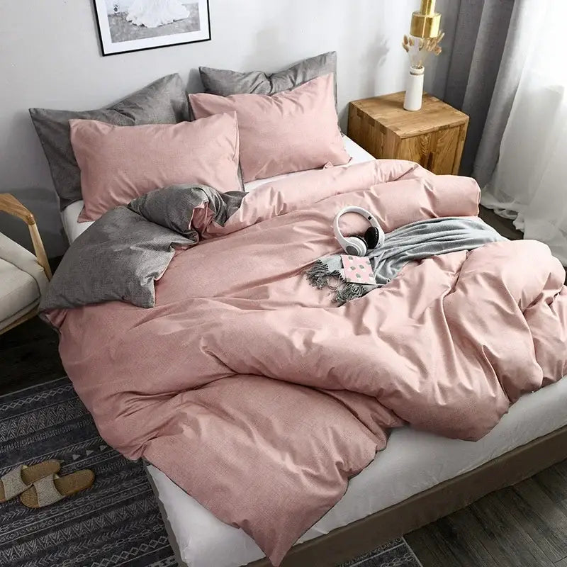 Pink and gray duvet cover set with matching pillowcases and gray accent pillows for bedroom bedding with throw blanket