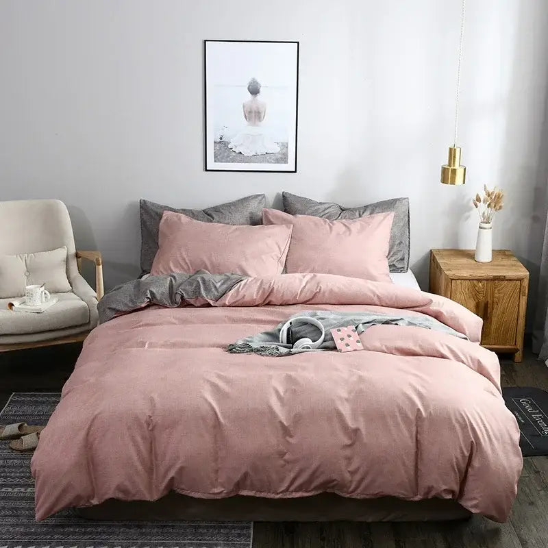 Pink and gray duvet cover set with matching pillowcases and a gray accent throw blanket for bedroom bedding