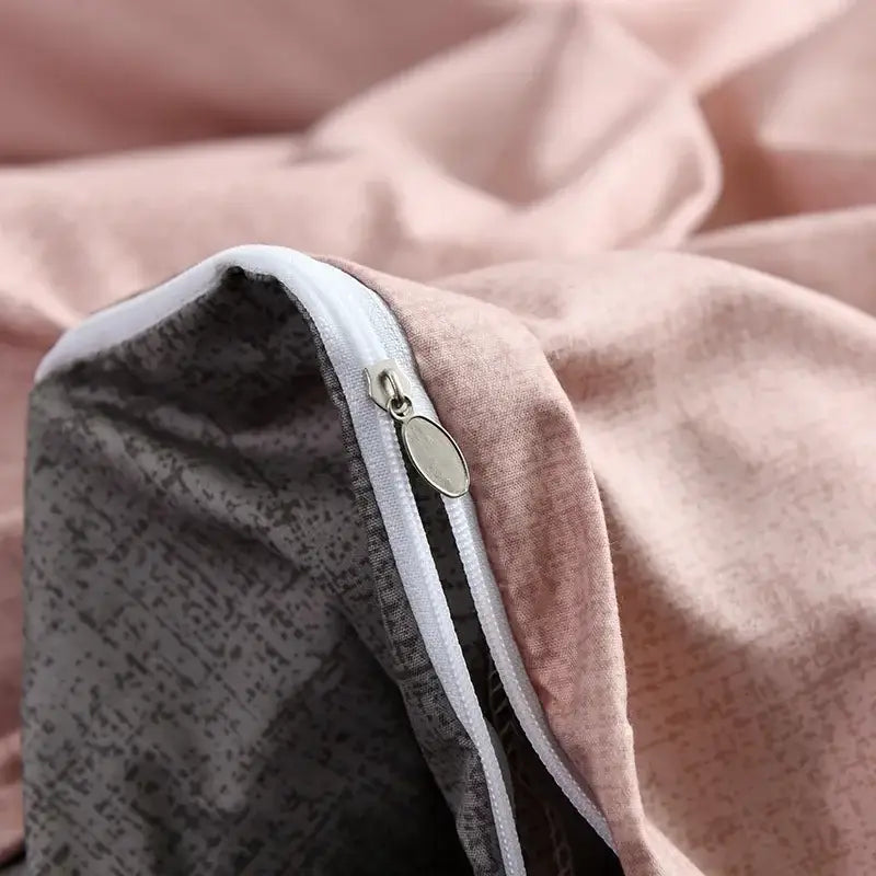 Soft pink and gray patterned duvet cover set with white zipper and oval metal pull tab for bedroom bedding