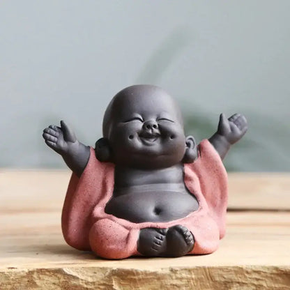Smiling chubby maitreya buddha statue tea sculpture with dark gray ceramic body and pink robe for living room decor