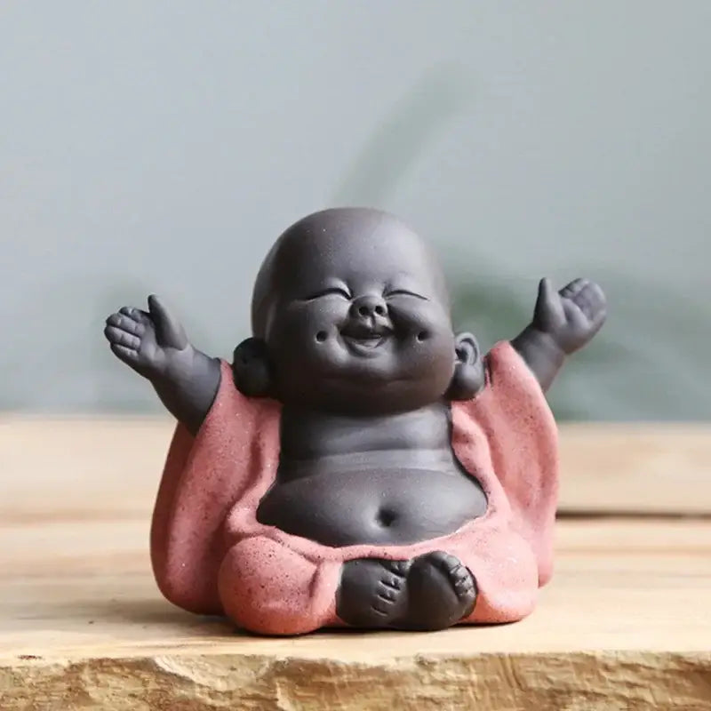 Smiling chubby maitreya buddha statue tea sculpture with dark gray ceramic body and pink robe for living room decor