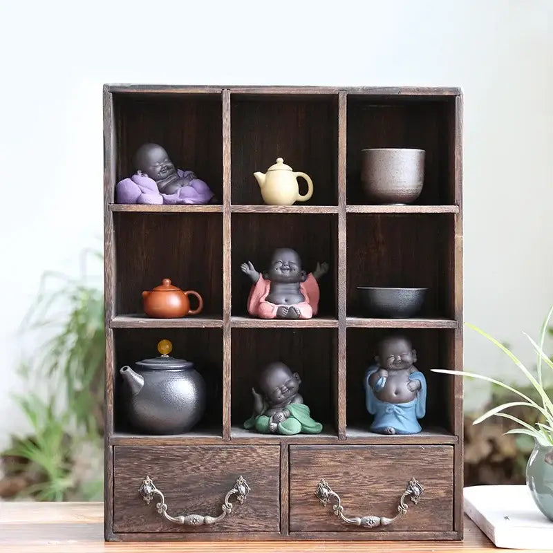 Dark wood nine-compartment display cabinet with ornate metal handles and drawers for buddha statue tea sculpture