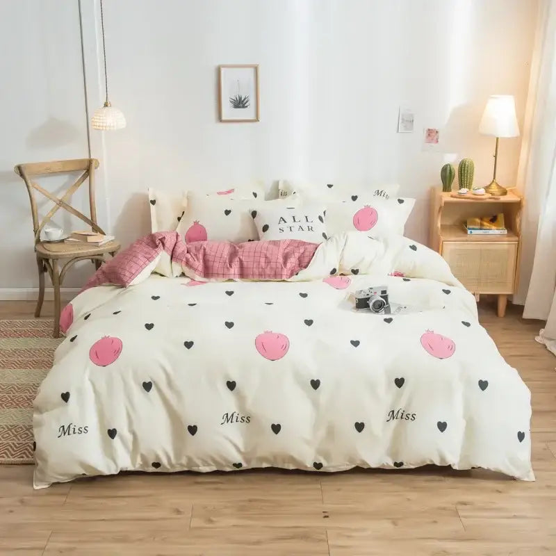 Cream-colored satin finish bedding set with pink peach and black heart decorbites cartoon print featuring miss design