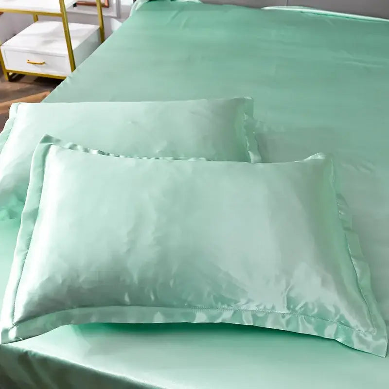 Mint green satin pillowcases with ruffled edges from pink ice rayon satin bedding set by decorbites for cooling comfort