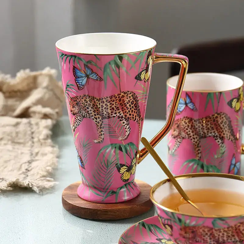Pink jungle animals bone china teacup with gold rim and handle featuring vibrant leopards butterflies and leaves decorbites jungle animals