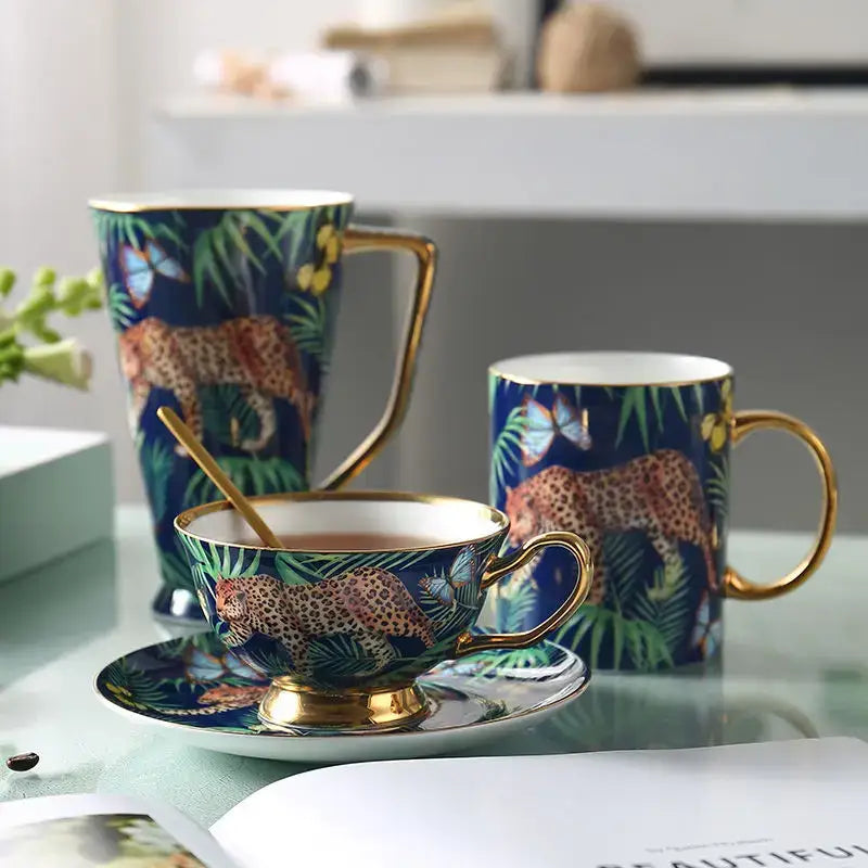 Blue bone china teacup with gold rim featuring detailed leopard and tropical foliage design from decorbites jungle animals