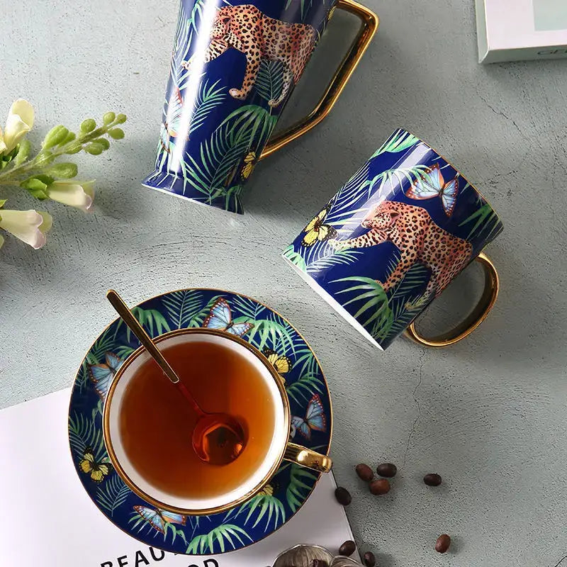 Deep blue ceramic teacup and saucer set with gold rims featuring vibrant jungle animals bone china design for dining room decorbites jungle animals