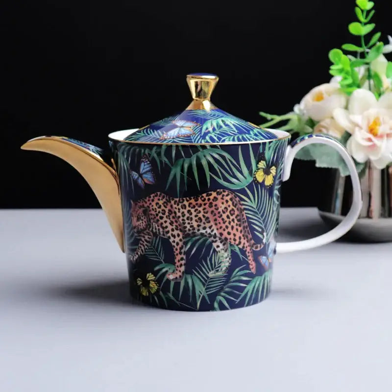 A navy blue ceramic teapot with gold trim featuring a leopard illustration for decorbites jungle animals bone china set