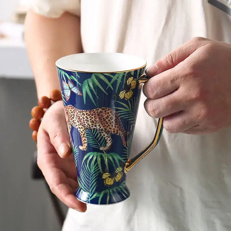 A navy blue ceramic mug with gold rim and handle featuring a leopard design for decorbites jungle animals bone china set
