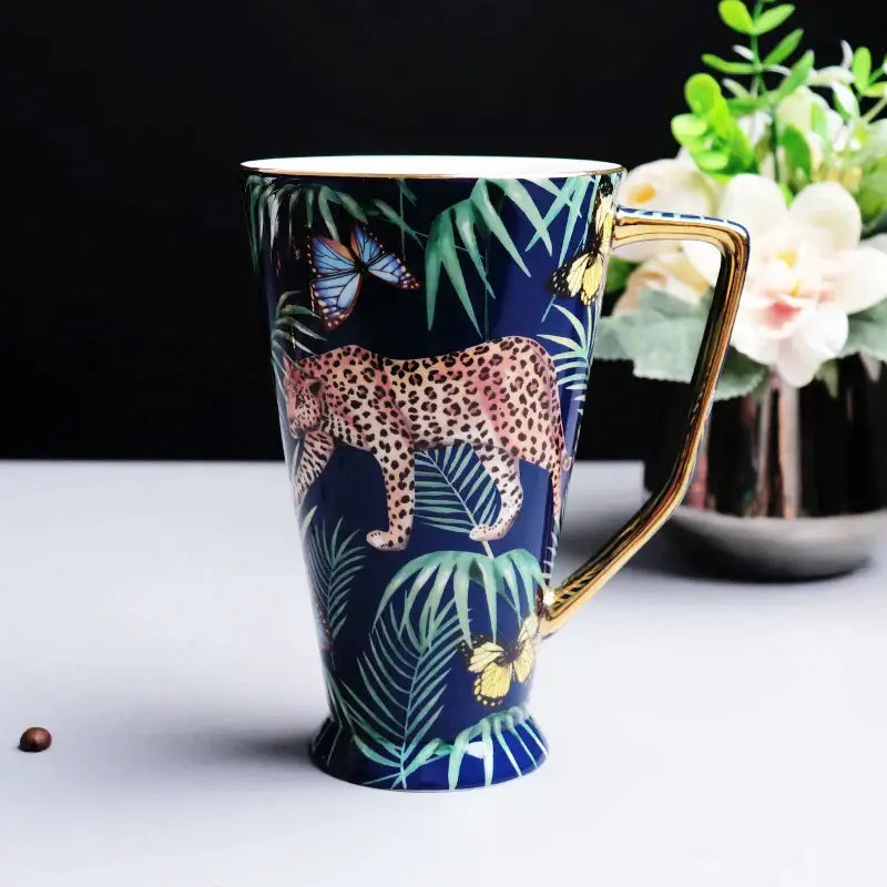 A navy blue ceramic mug with gold rim and leopard illustration from the pink jungle animals bone china set