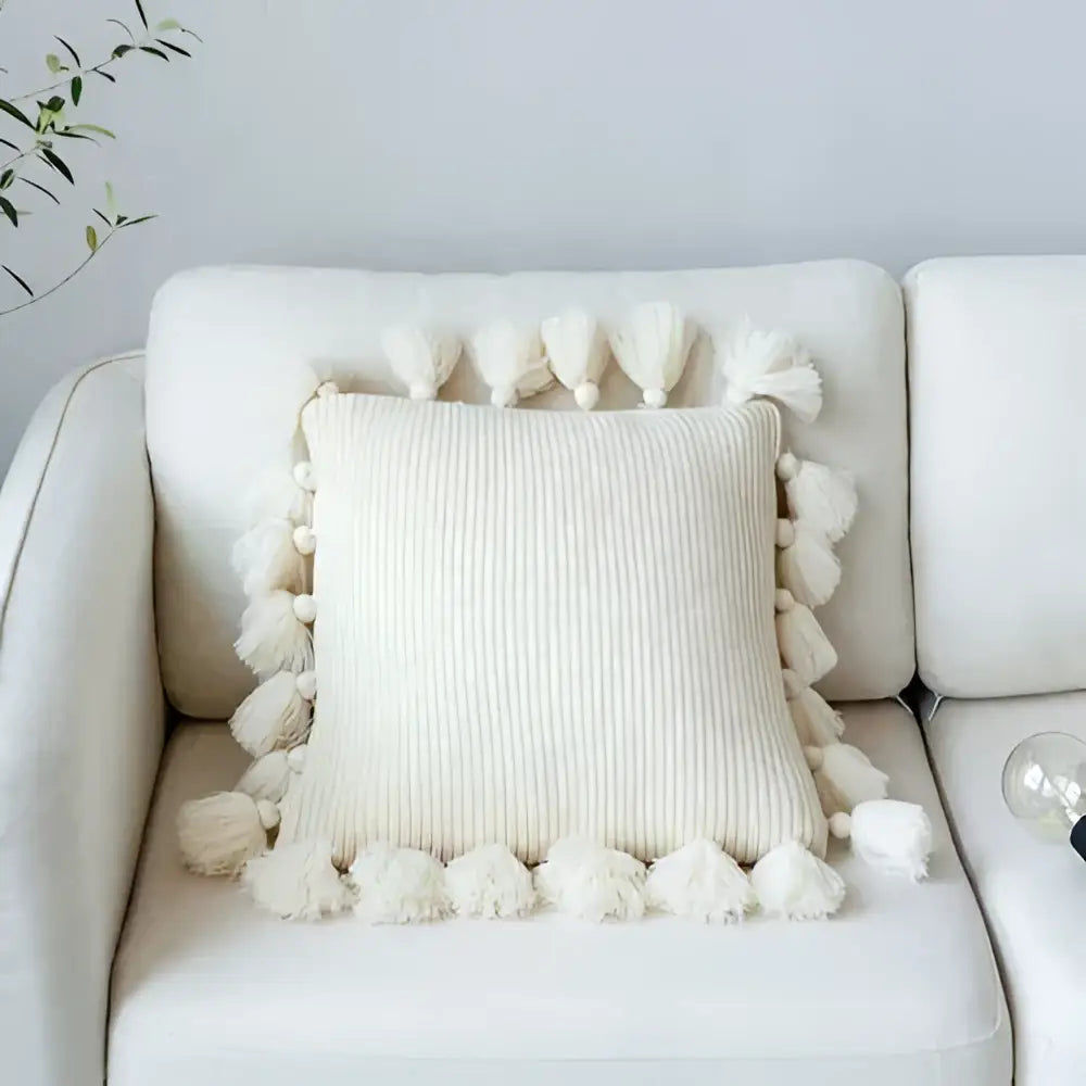 Cream-colored ribbed knit cushion cover with fluffy tassels on all sides for decorbites knit cushion cover living room decor
