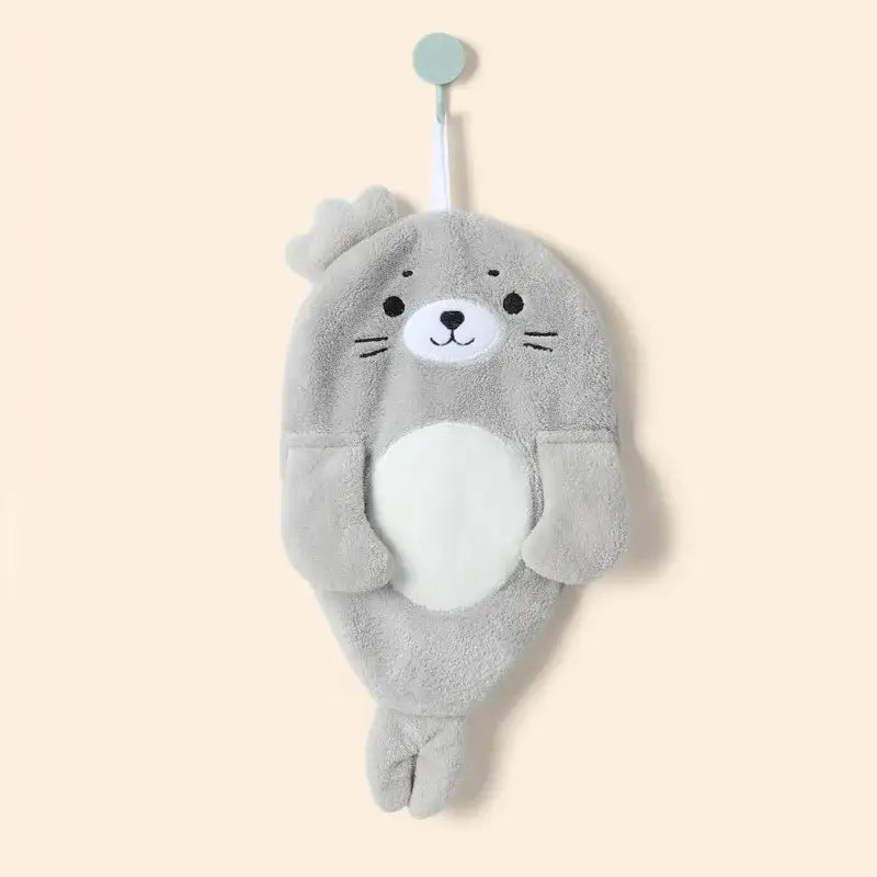 A soft gray plush seal cartoon animal shape towel with white belly and embroidered features for decorbites cartoon animal decor