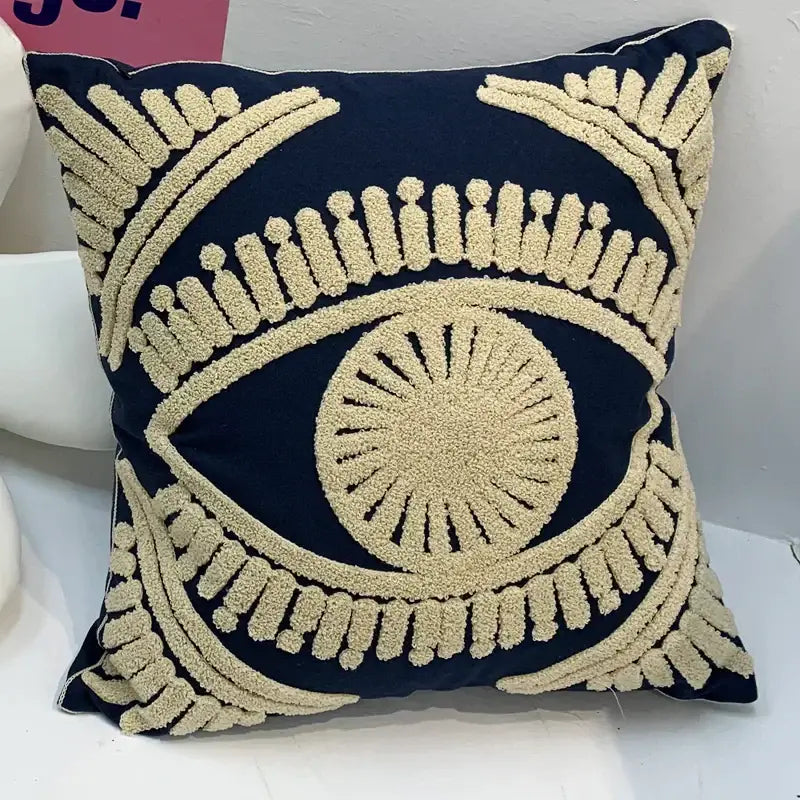 Navy blue cotton throw pillow cover with cream embroidered eye design for living room decor