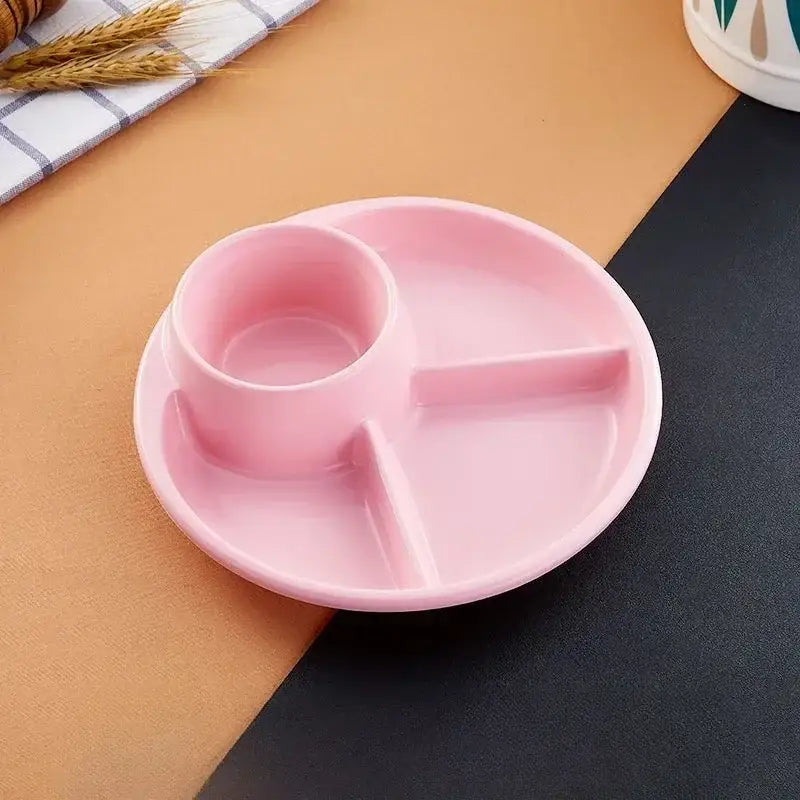 Pink plastic portion control plate with central cup section and two compartments for kids meal dining use