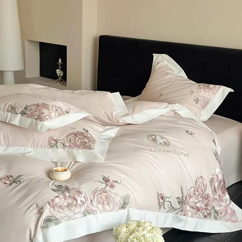 Pink floral embroidered satin bedding set with white piping and endless ocean text featuring pink purple flowers in egyptian cotton
