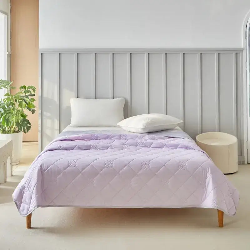 Lavender quilted cool summer blanket with subtle floral embroidery and diamond-stitched pattern for bedroom comfort
