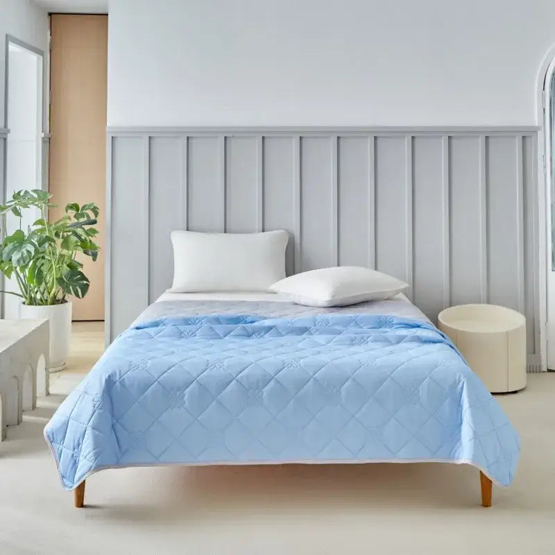 Light blue quilted summer blanket with diamond pattern for cool summer bedroom comfort and cooling use