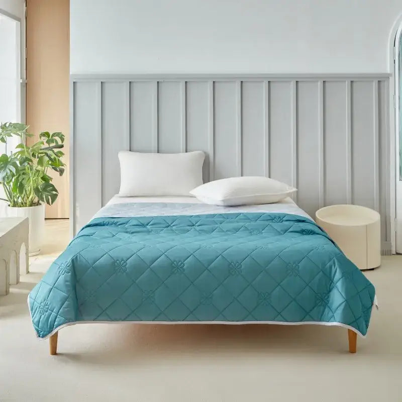 Teal quilted cool summer blanket with diamond pattern and white border for bedroom cooling comfort