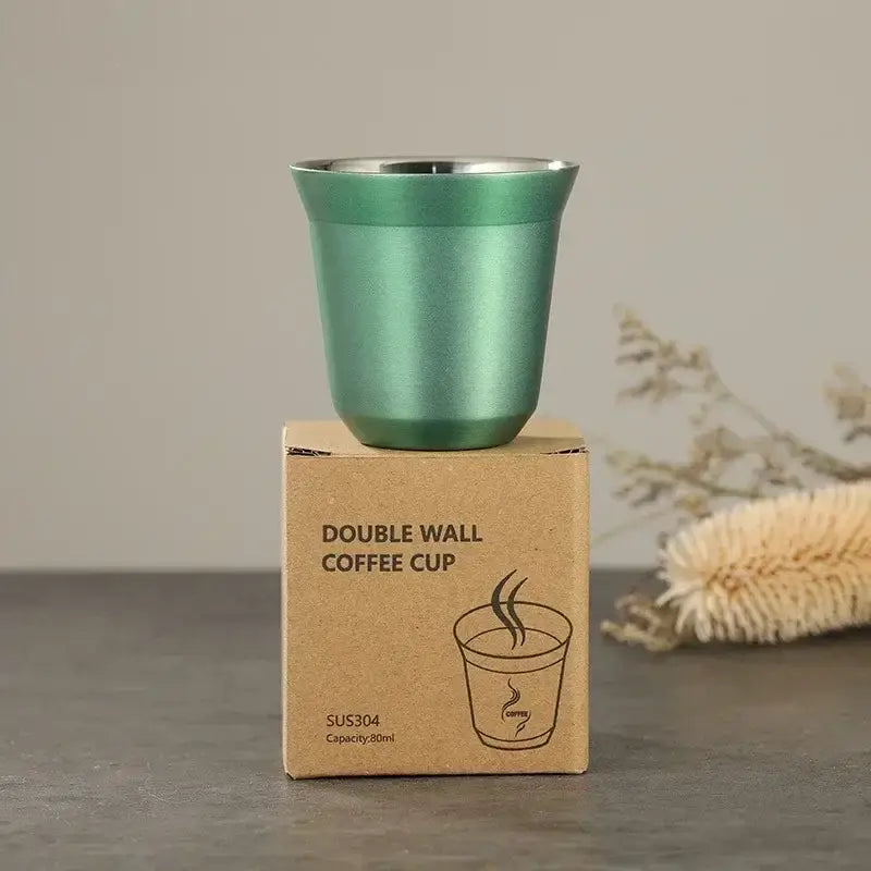 A sleek matte green double wall espresso cup with stainless steel rim on cardboard packaging in set of 3 mugs